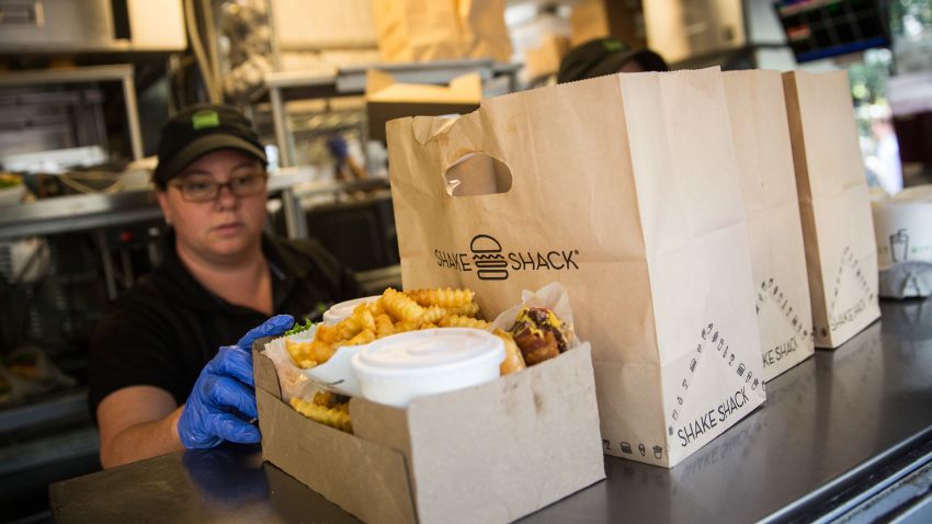 NEW YORK, NY - AUGUST 18:  Shake Shack workers prepare orders on August 18, 2014 in Madison Square Park in New York City. Shake Shack is allegedly considering going public and holding an initial price offering (IPO).  (Photo by Andrew Burton/Getty Images)