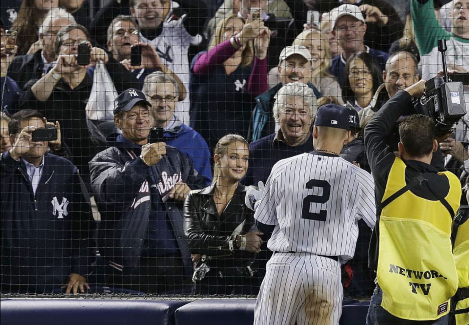 Jeter greets his girlfriend, model Hannah Davis, and some of his family members after playing his last home game. Jeter married Davis in 2016.