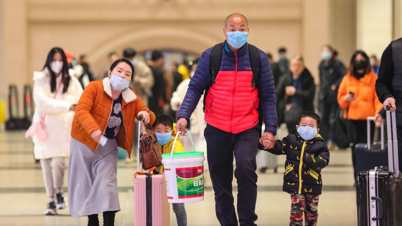 Commuters wearing face masks walk in Hankou railway station in Wuhan, where China's coronavirous outbreak first emerged last month.