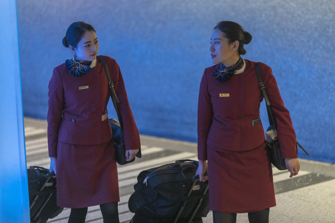 Air China flight attendants arrive at Los Angeles International Airport after touchdown from Beijing, which serves as a connector from Wuhan, on the first day of health screenings for coronavirus. 