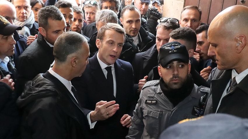 French President Emmanuel Macron asks the Israeli police to leave the 12th-century Church of Saint Anne in the old city of Jerusalem on January 22, 2020. - World leaders are to travel to Israel this week to mark 75 years since the Red Army liberated Auschwitz, the extermination camp where the Nazis killed over a million Jews. Thousands of police officers and other security forces will deploy from today, ahead of the arrival of dignitaries including Russian President Vladimir Putin, French President Emmanuel Macron and US Vice President Mike Pence. (Photo by Ludovic Marin / AFP) (Photo by LUDOVIC MARIN/AFP via Getty Images)
