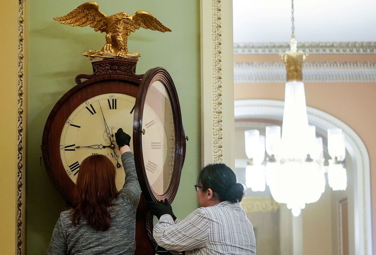Capitol employees wind the historic Ohio Clock on January 21.
