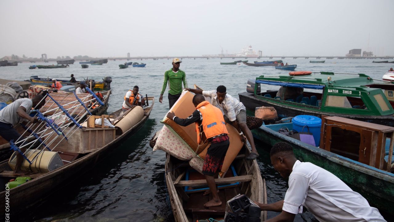 Tarkwa Bay residents pack their belongings on boats on Tuesday after military personnel from the Nigerian navy invaded the community. Photo: Omoregie Osakpolor