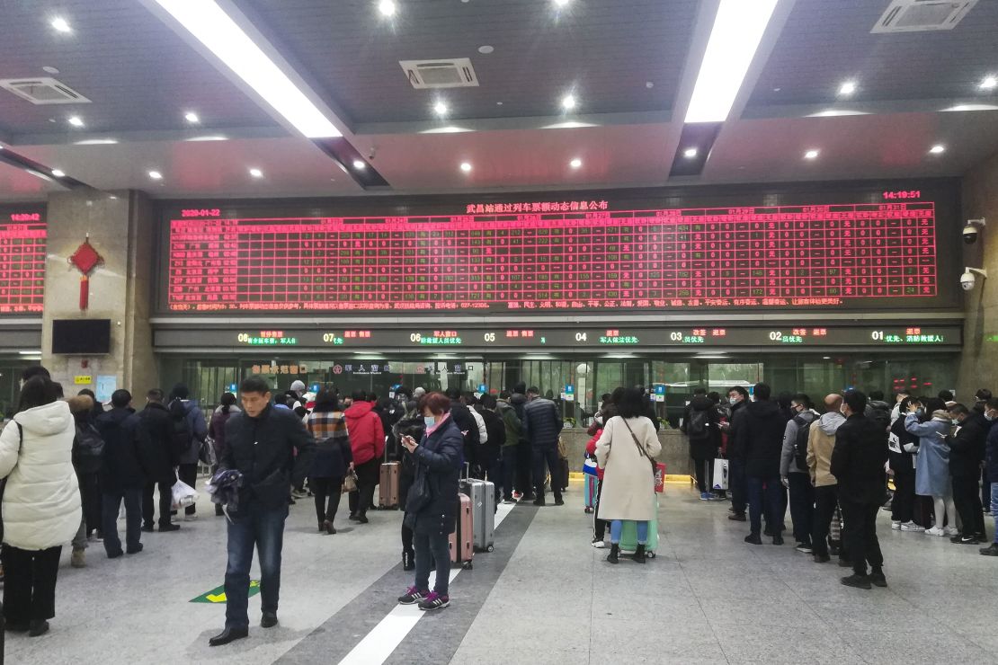 Commuters wait in line at Wuchang railway station in Wuhan on Wednesday.