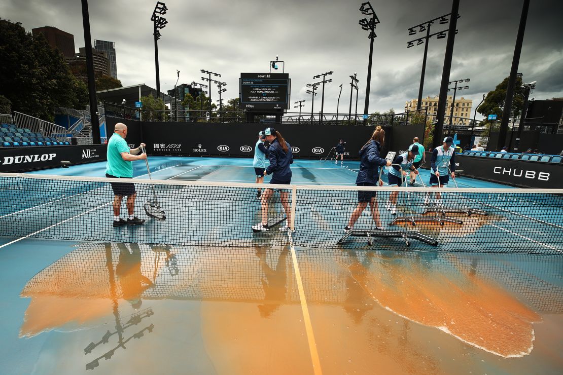 Staff cleaning dirt off the outside courts at Melbourne Park on January 23, 2020 in Melbourne, Australia.