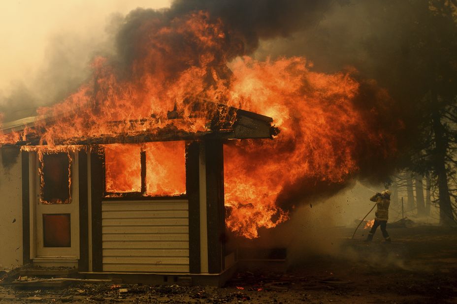 A firefighter battles the Morton Fire as it consumes a home near Bundanoon on January 23. 