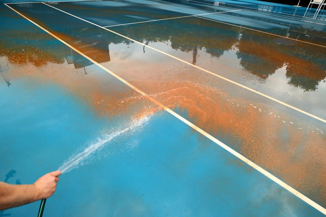 High-pressure cleaning was required to clear the outside courts at Melbourne Park. 