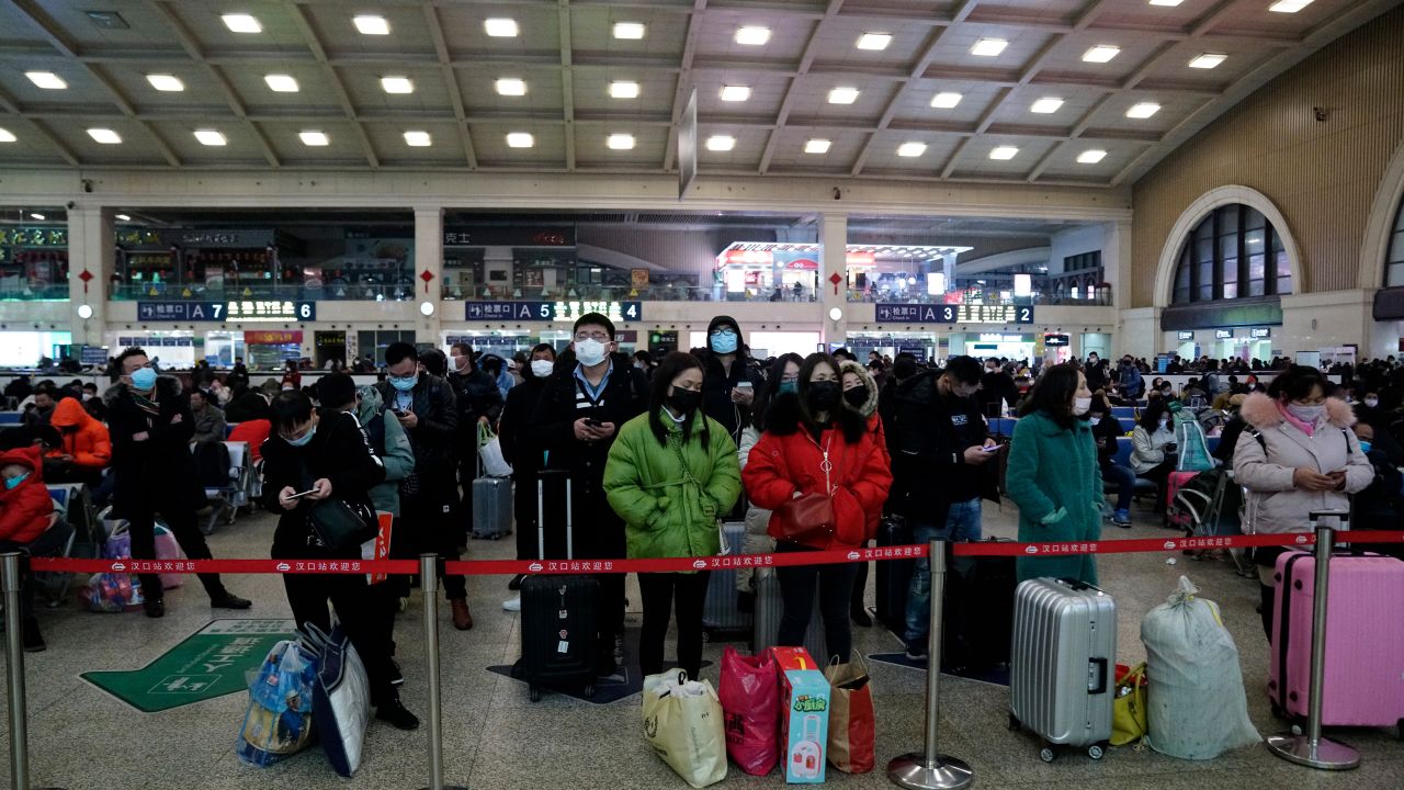 Travelers at Wuhan's Hankou railway station queue to leave the city early on Thursday morning before the citywide lockdown came into effect.