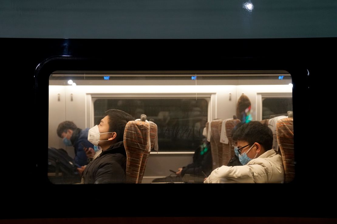Passengers wearing face masks onboard one of the last trains to leave Wuhan before a citywide lockdown came into effect.
