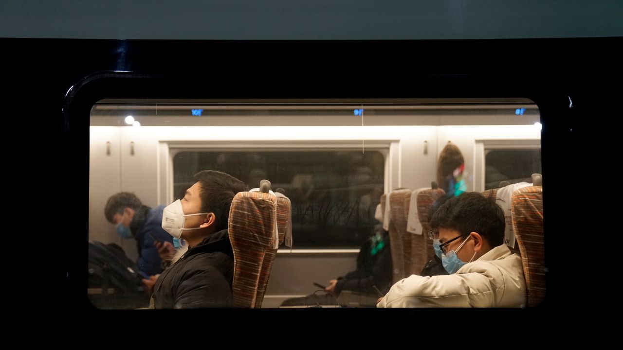 Passengers wearing face masks onboard one of the last trains to leave Wuhan before a citywide lockdown came into effect.