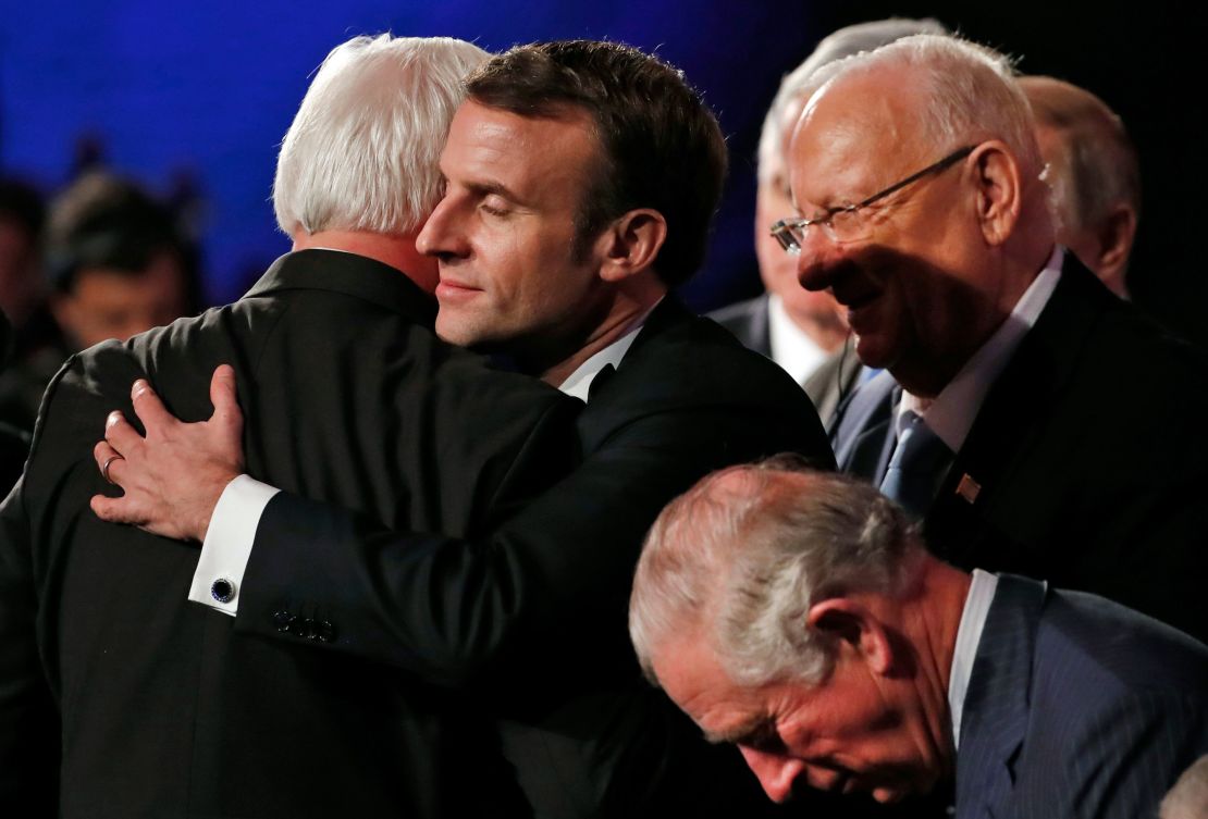 German President Frank-Walter Steinmeier (left) and his French counterpart Emmanuel Macron (center) hug.