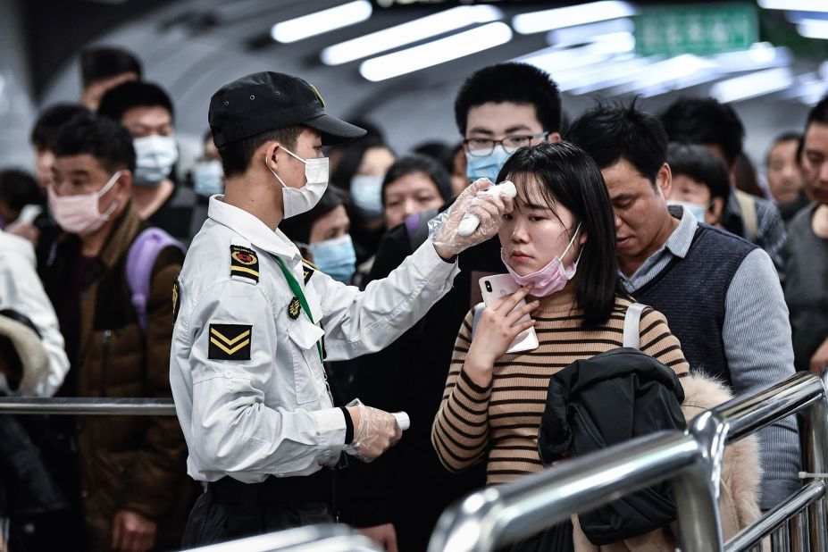 People go through a checkpoint in Guangzhou on January 22.