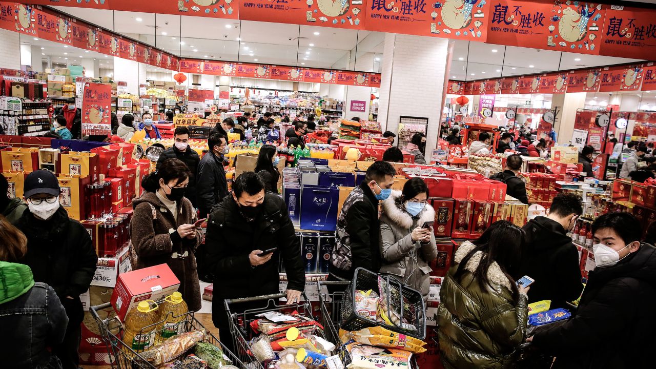 Residents wear masks to buy vegetables in the market on January 23, 2020, in Wuhan, Hubei, China.