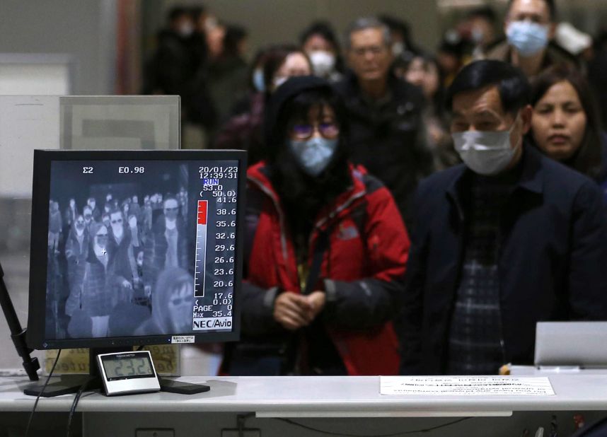 Passengers are checked by a thermography device at an airport in Osaka, Japan, on January 23.