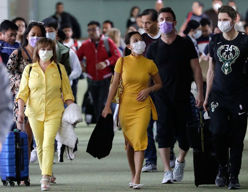 Passengers wear masks as they arrive at the Ninoy Aquino International Airport in Manila, Philippines, on January 23, 2020.