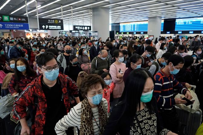 Passengers wear masks at a high-speed train station in Hong Kong on January 23, 2020.