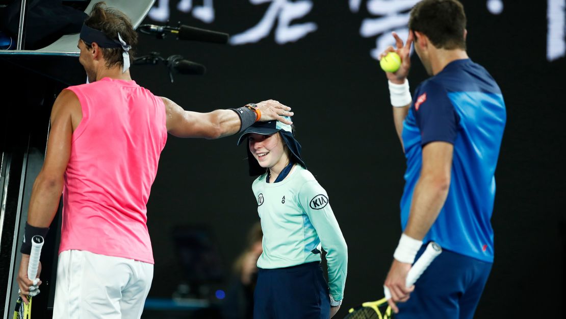 Nadal checks to see if the ball kid is OK after she was struck by a ball.