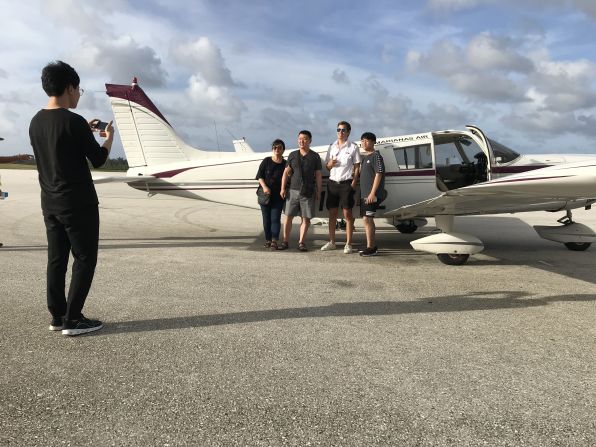 <strong>Celeb status: </strong>Star Marianas Air pilot Kai Frenay poses with passengers before leaving on a quick flight to Saipan. 