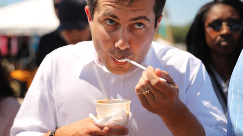 DES MOINES, IOWA - AUGUST 13: Democratic presidential candidate and South Bend, Indiana, Mayor Pete Buttigieg drinks a root beer float while talking with journalists as he walks through the Iowa State Fair August 13, 2019 in Des Moines, Iowa. Twenty-two of the 23 politicians seeking the Democratic Party presidential nomination visited the fair this week, six months ahead of the all-important Iowa caucuses (Photo by Chip Somodevilla/Getty Images)