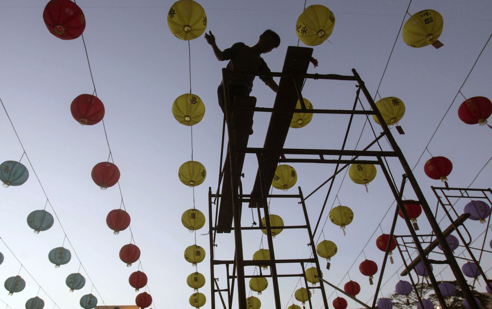 A worker arranges lanterns in preparation of the upcoming Chinese Lunar New Year at Maitreya temple in Medan, North Sumatra, Indonesia. The Chinese communities in the world's most populous Muslim country are gearing up to celebrate the start of the year of the rat.