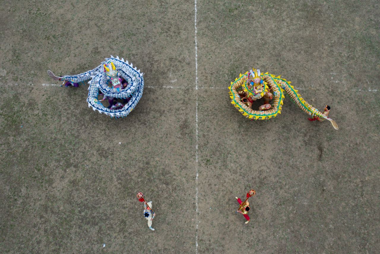 Folk artists perform a dragon dance in Langzhong, in China's Sichuan province, on Saturday, January 18. 