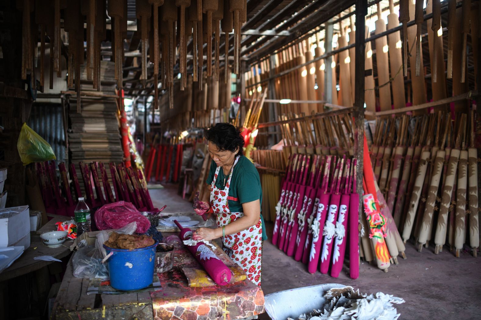 A worker decorates giant incense sticks at a factory in Kubang Semang, in western Malaysia, on Friday, January 17.