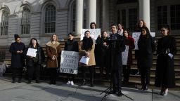 Marissa Hoechstetter, center, and her attorney, Anthony DiPietro, at the microphone, joined supporters Thursday at New York's City Hall to call for the resignation of Manhattan District Attorney Cyrus Vance. They say he was too lenient with Robert Hadden, the former Columbia University OB-GYN who stands accused of sexually abusing dozens of women.