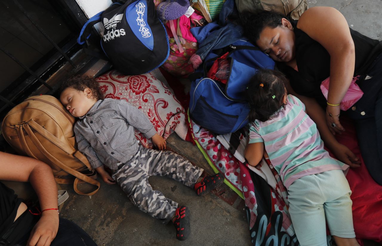 Honduran migrants rest as they wait to cross into Mexico in Tecun Uman, Guatemala, on Friday, January 17. Border security forces in southern Mexico were preparing Friday for the expected arrival of hundreds of Central Americans traveling through Guatemala in hopes of reaching the United States.