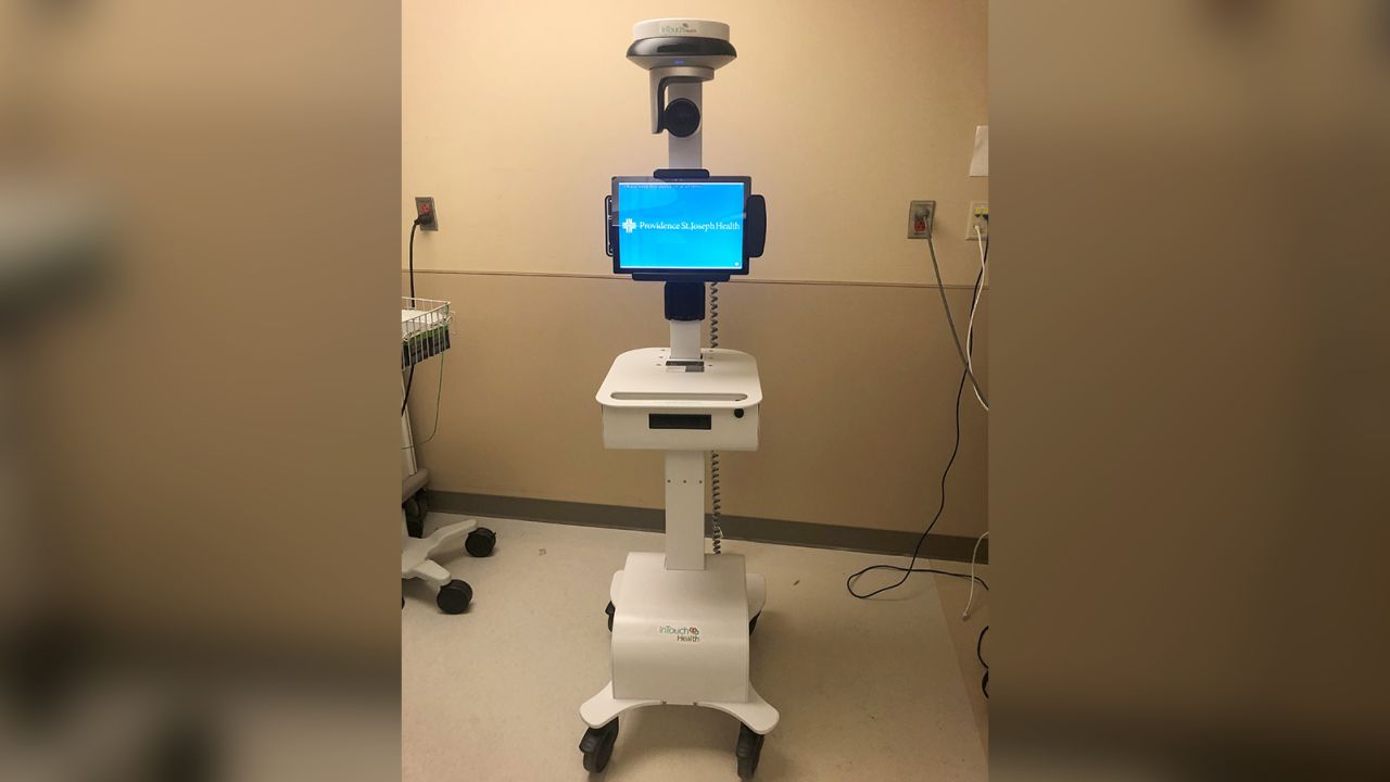Doctors are using a robot to communicate with the man from outside the isolation area.