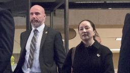 Meng Wanzhou, chief financial officer of Huawei, is flanked by security as she leaves B.C. Supreme Court in Vancouver, Thursday, January 23, 2020. Wanzhou is in court for hearings over an American request to extradite the executive of the Chinese telecom giant Huawei on fraud charges.(Jonathan Hayward/The Canadian Press via AP)