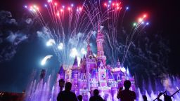This photo taken on June 16, 2017 shows visitors watching fireworks exploding over the castle at an event to mark the first anniversary of the opening of Shanghai Disneyland, in Shanghai.