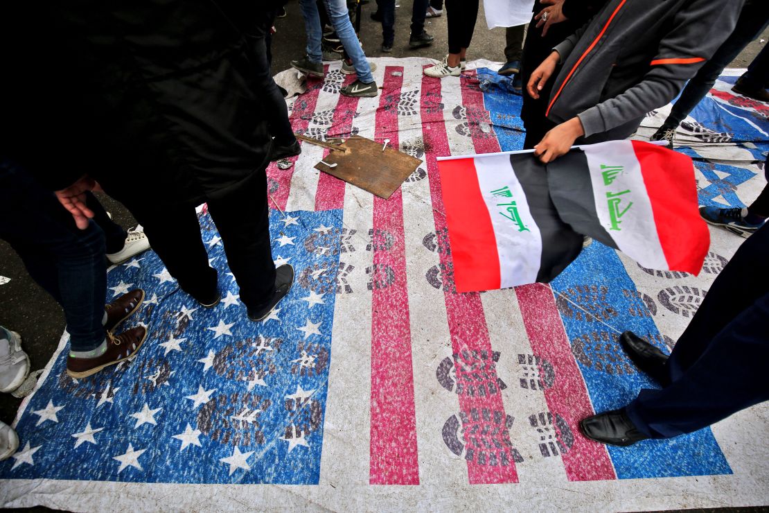 Protesters step on a makeshift US flag after heeding the call of powerful Shia cleric Muqtada al-Sadr for a "Million Man March."