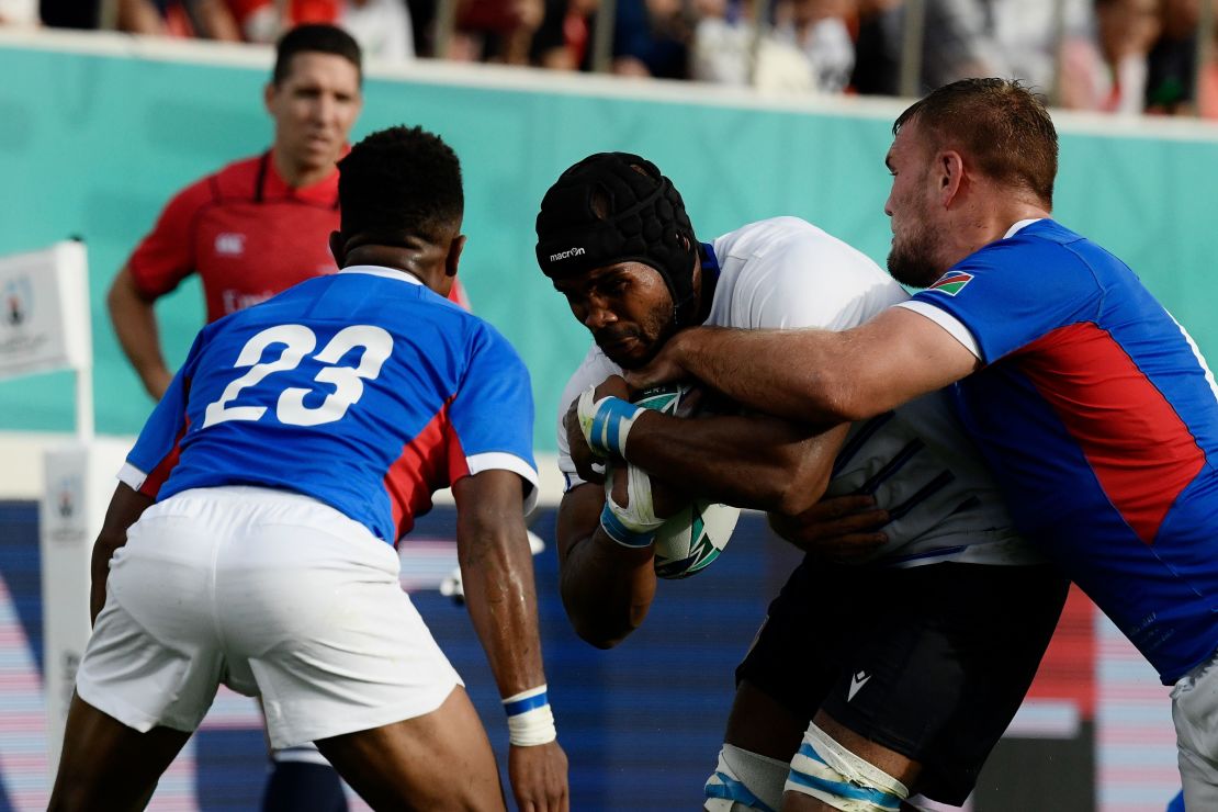 Mbanda is tackled during Italy's Rugby World Cup pool game against Namibia. 