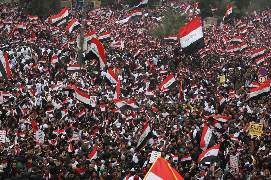 Hundreds of thousands of Iraqis, waving national flags, take to the streets in central Baghdad on January 24, 2020. 