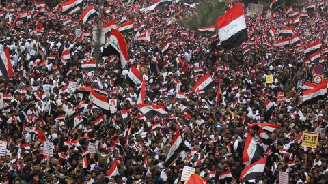 Hundreds of thousands of Iraqis, waving national flags, take to the streets in central Baghdad on January 24, 2020. 