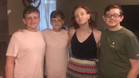 Landon Durham, right, poses for a photo with his mother and twin brothers in this photo posted to Facebook by his mother last year.