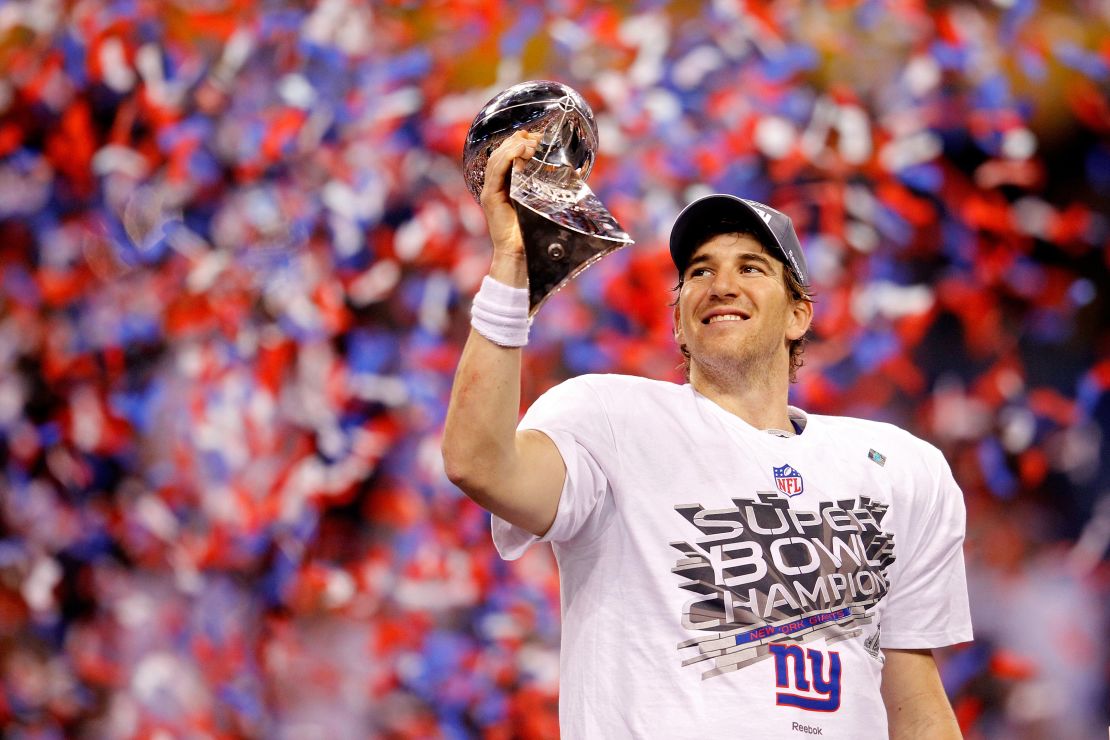 Giants quarterback Eli Manning lifts the Vince Lombardi Trophy after winning Super Bowl XLVI.