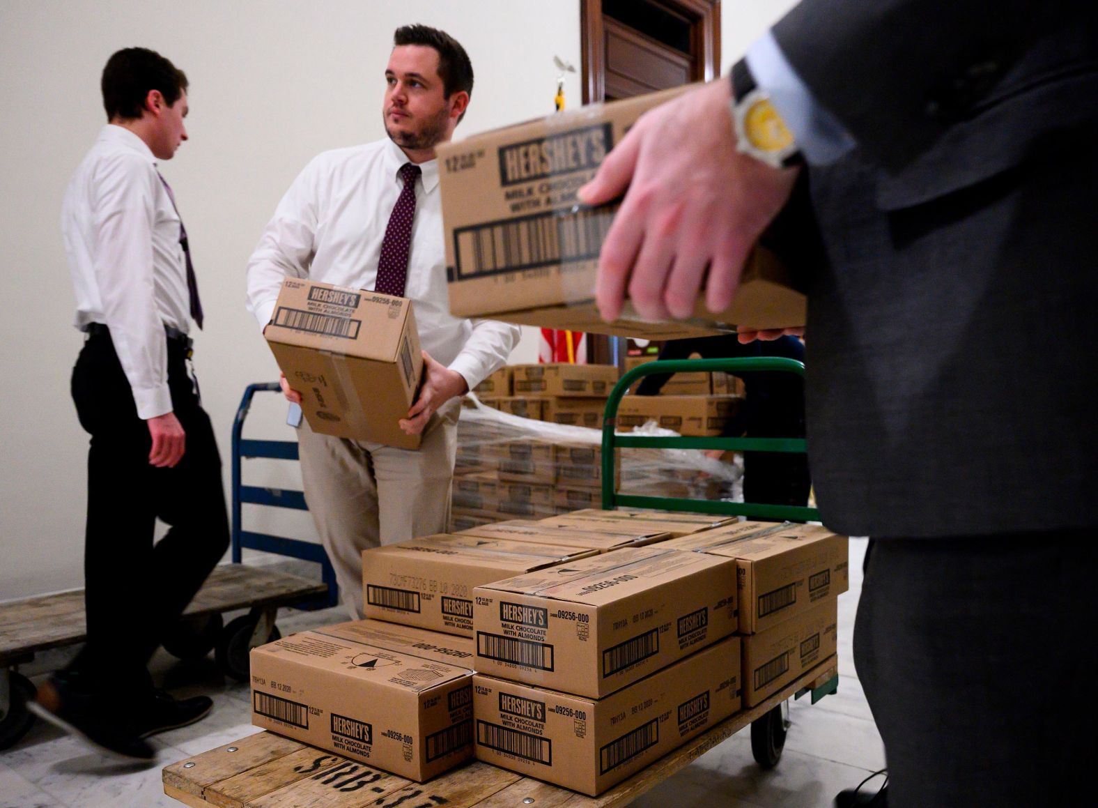 Staff members load boxes of Hershey's candy onto carts outside the office of Sen. Pat Toomey on January 24. Hershey's sent the candy to resupply Toomey's desk on the Senate floor, known as the candy desk, for the impeachment trial. 