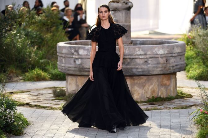 A model presents a creation by Chanel during the Women's Spring-Summer 2020/2021 Haute Couture collection fashion show at the Grand Palais in Paris, on January 21, 2020. - The Grand Palais was turned into the garden of the Cistercian abbey in Aubazine, central France, where Gabrielle "Coco" Chanel grew up. (Photo by CHRISTOPHE ARCHAMBAULT / AFP) (Photo by CHRISTOPHE ARCHAMBAULT/AFP via Getty Images)