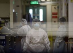 Medical staff wearing protective gear go about their duties in the Alice Ho Miu Ling Nethersole Hospital in Tai Po where seven hospital workers have gone down with flu-like symptoms on August 27, 2003. 