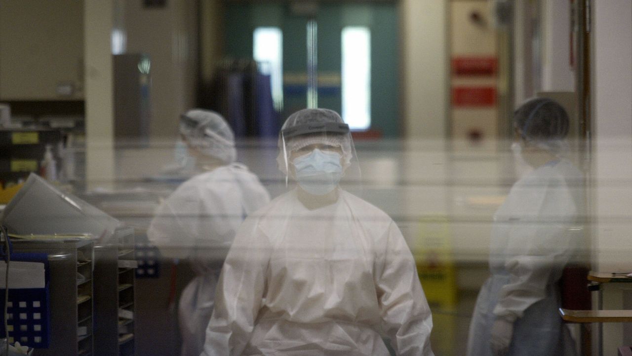 Medical staff wearing protective gear go about their duties in the Alice Ho Miu Ling Nethersole Hospital in Hong Kong after seven hospital workers reported flu-like symptoms on August 27, 2003.