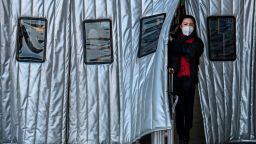 A Chinese woman wears a protective mask as she leaves a Beijing railway station on January 23, 2020 in Beijing, China. 