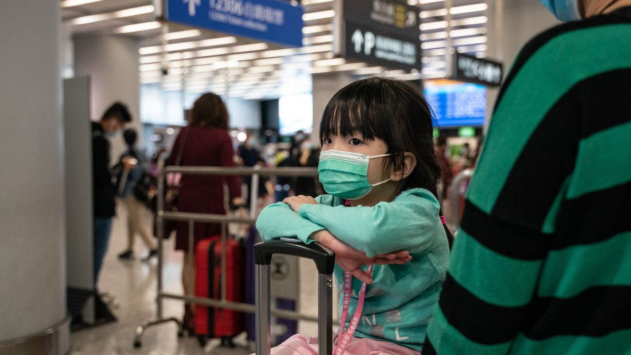 Travelers wearing face masks wait at the departure hall at West Kowloon Station on January 23, 2020 in Hong Kong.