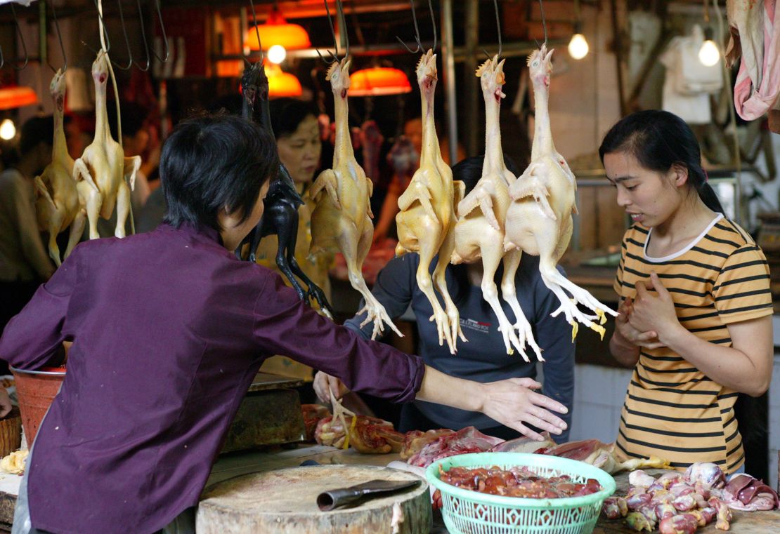 In 2003, a fresh food market continues to trade despite the threat of the SARS virus in Guangzhou, the capital of Guangdong province, China. 