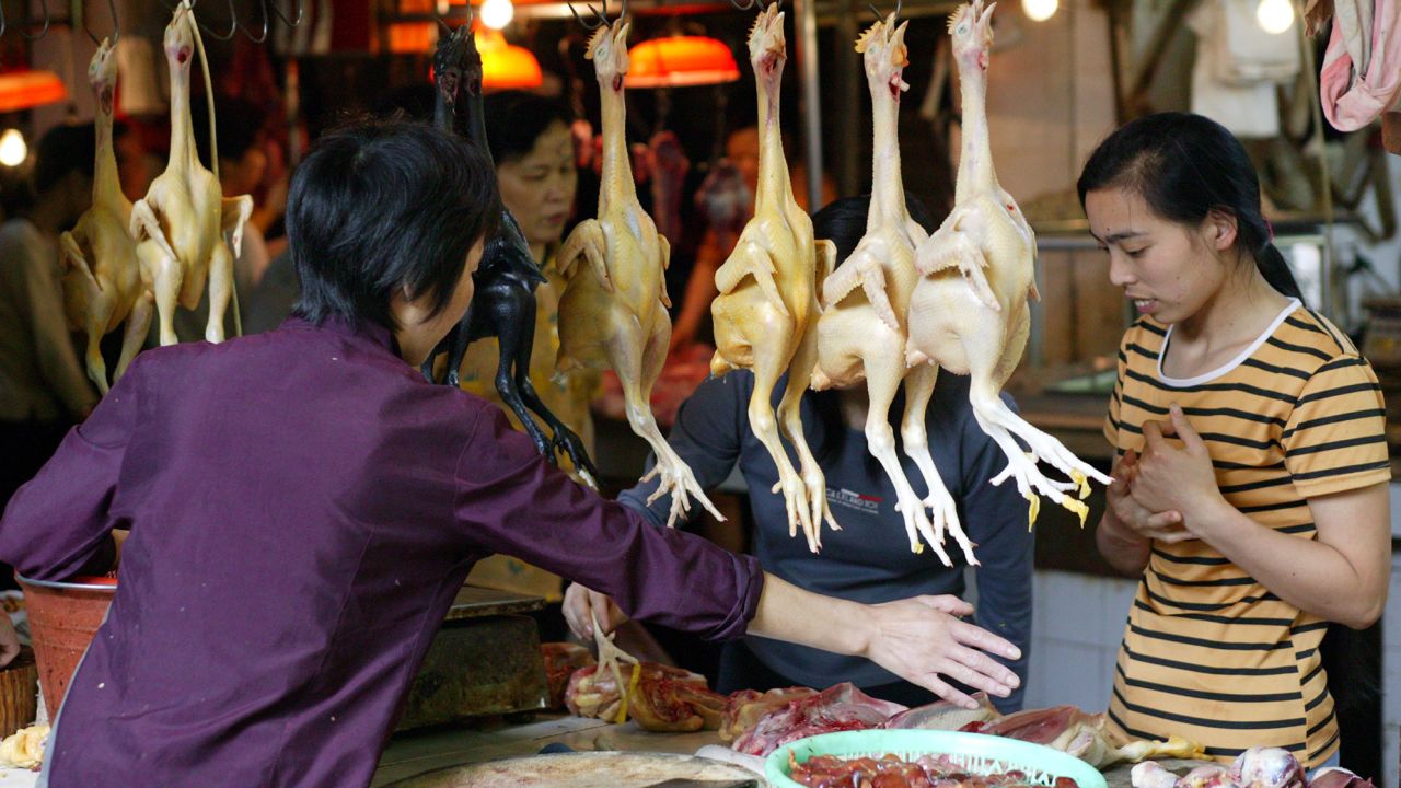 In 2003, a fresh food market continues to trade despite the threat of the SARS virus in Guangzhou, the capital of Guangdong province, China. 