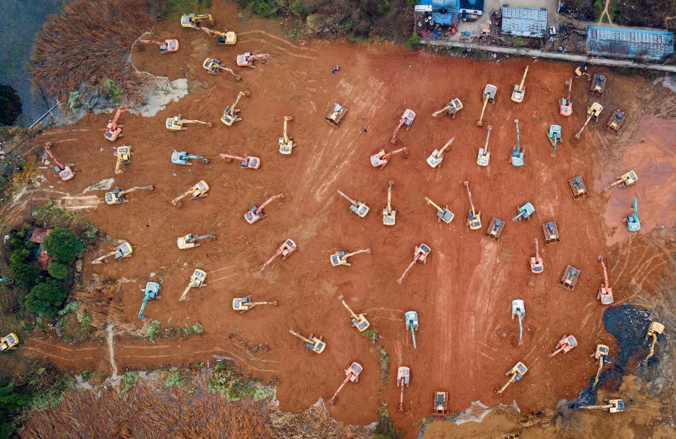 Construction workers in Wuhan begin to work on a special hospital to deal with the outbreak.