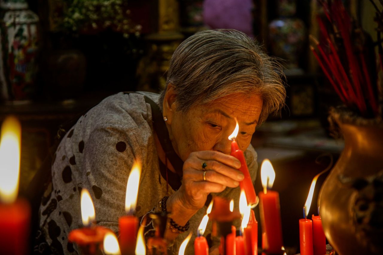 A woman lights a candle at a temple in Kolkata, India, on January 25.