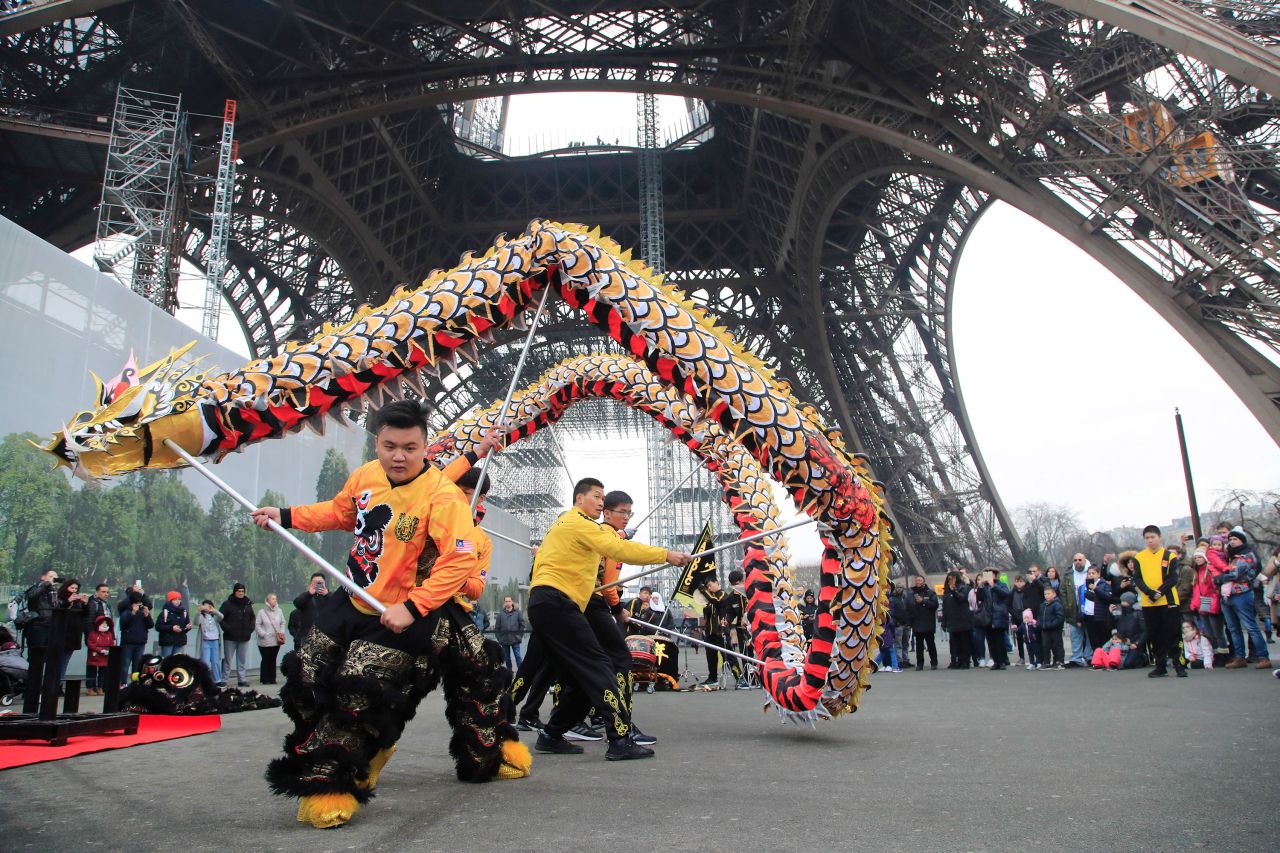 Members of the Chinese community dance at the Eiffel Tower in Paris on January 25.