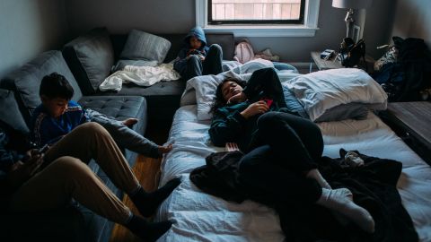 Alejandro Quiles, 16, left, his brother Alexander, 7, middle-left, their sister Ronalys, 17, on the inflatable mattress, and their cousin Sebastián Quiñones, 10, middle, lounge around on a quiet morning in New York.