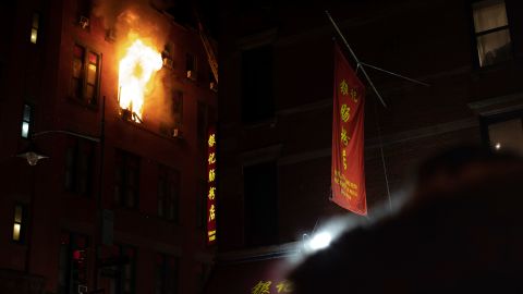 Fire blows out of a window in the Chinatown section of New York, Thursday, Jan. 23, 2020. 